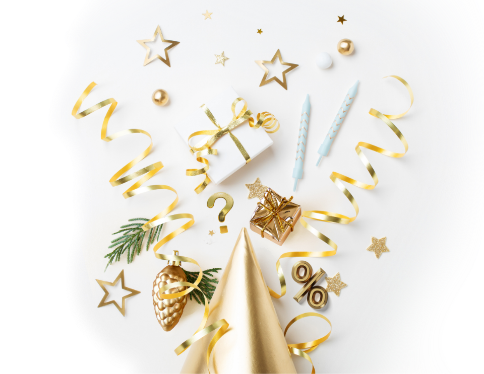 Festive party celebration items, like a gift box, tinsel stars and candles.