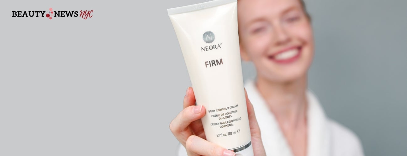 Image of a smiling woman holding a bottle of Firm Body Contour Cream.