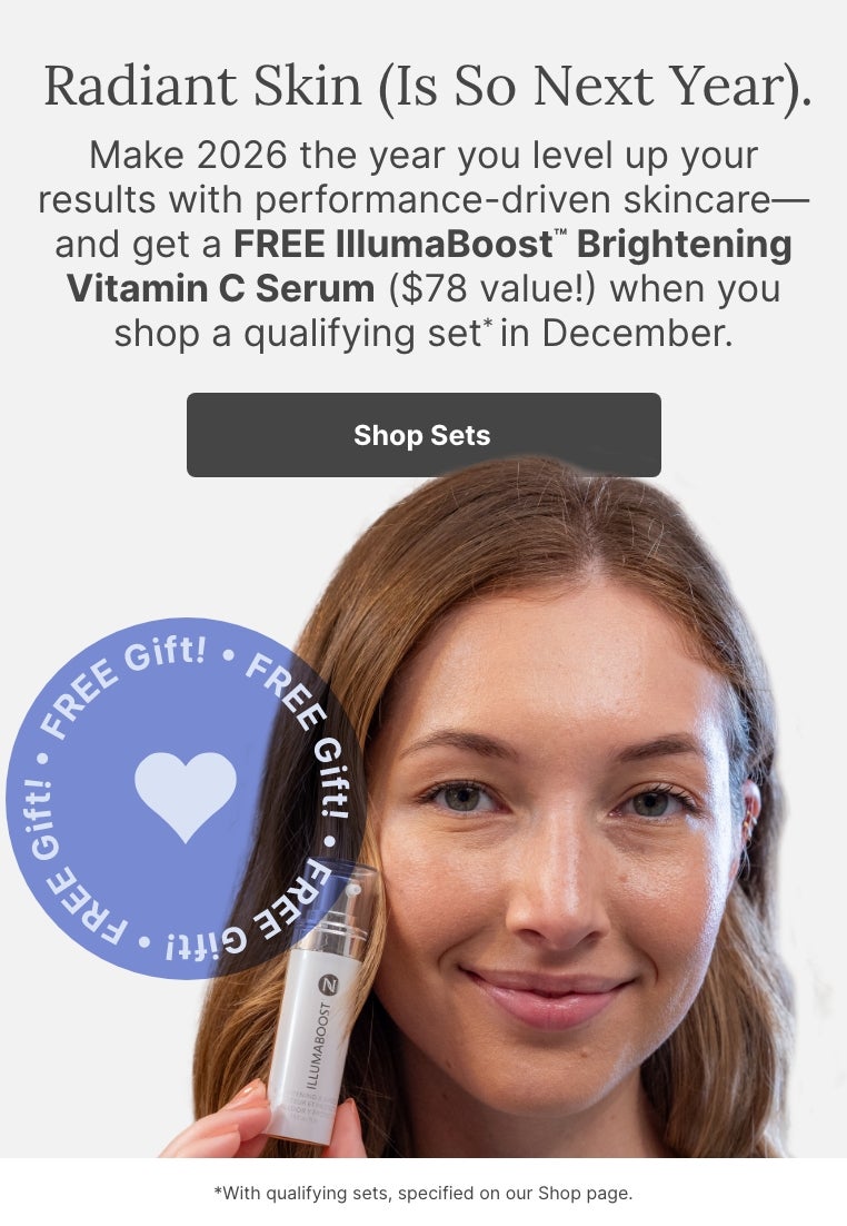 A woman holding a bottle of Neora’s IllumaBoost. Accompanying text mentions that you can get a FREE IllumaBoost Brightening Vitamin C Serum ($78 value) when you shop a qualifying set in December.
