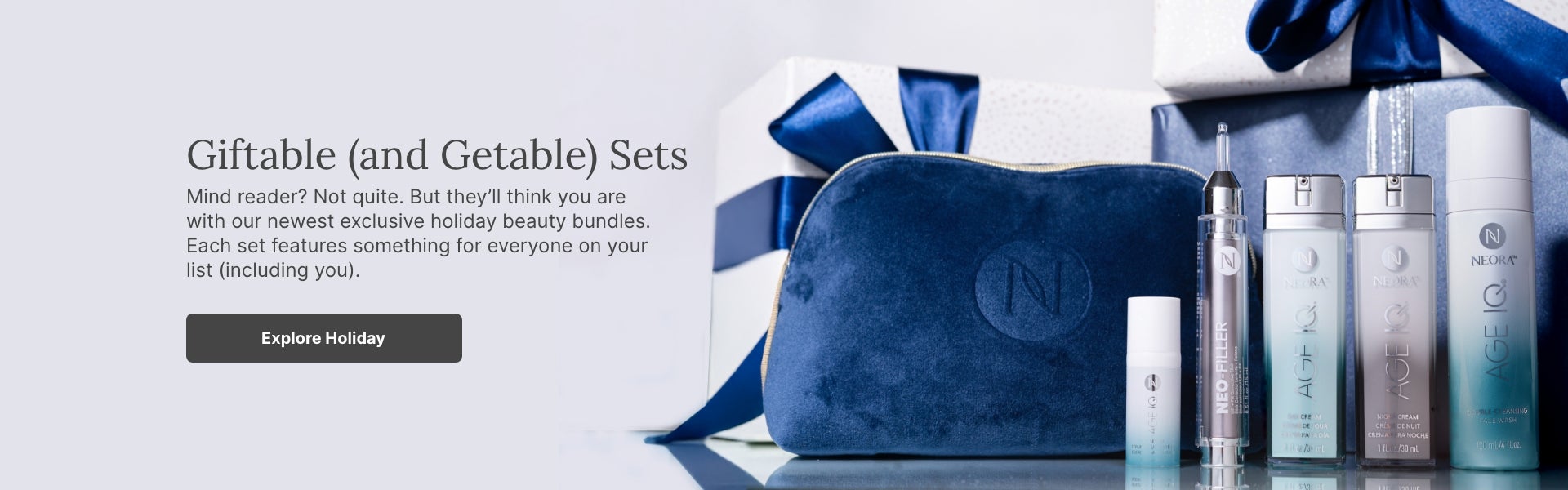 A bundle of Neora skincare products and a blue velvet Neora branded bag surrounded by festive gift boxes. Accompanying text mentions Neora’s newest exclusive holiday beauty bundles that are perfect for gifting to others or yourself.