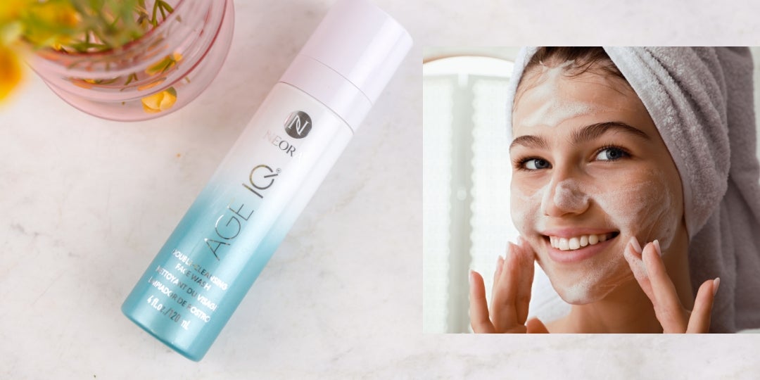 A young woman applies Age IQ Double-Cleansing Face Wash to her face.